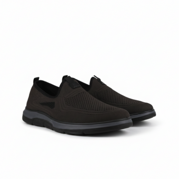 Pair of black slip-on shoes on a white background