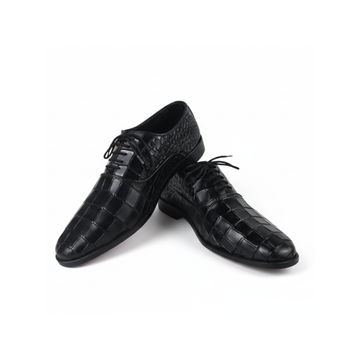 Pair of black dress shoes with textured finish on a white background