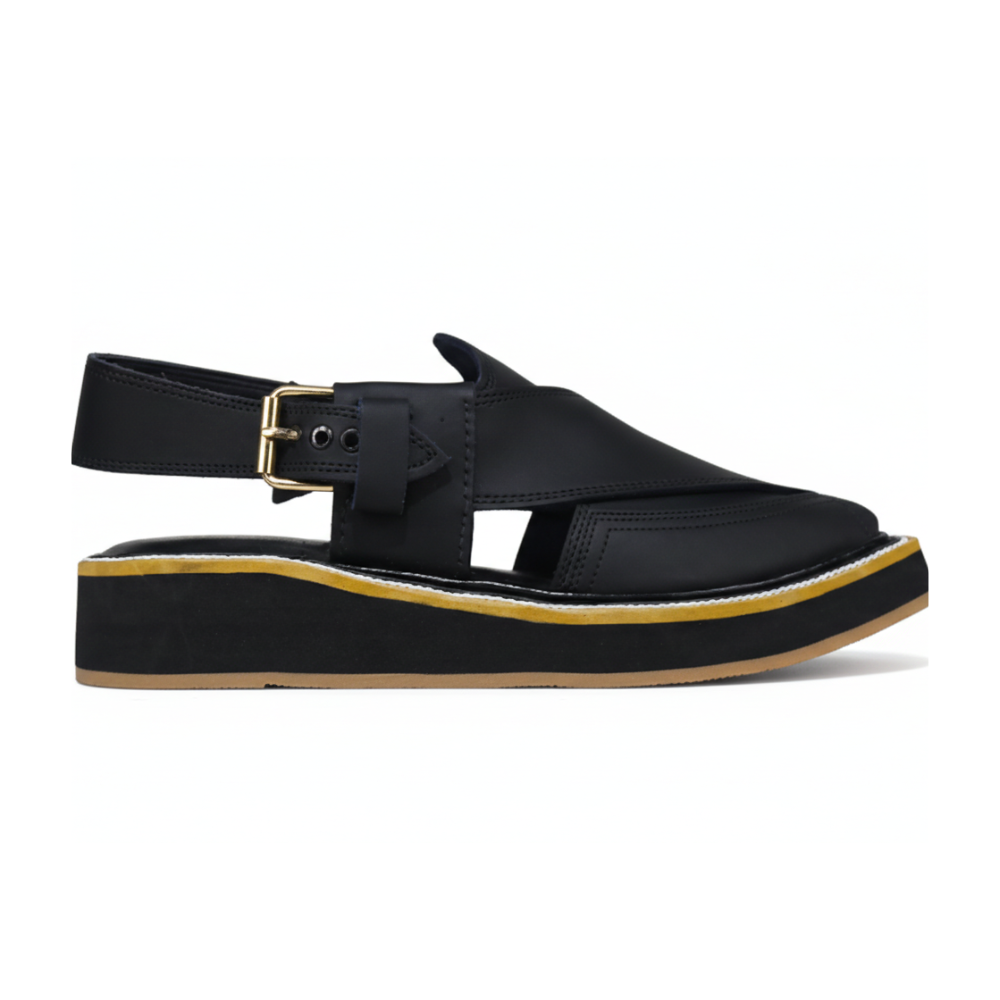 Black peshawari cahppal with a gold buckle on a white background