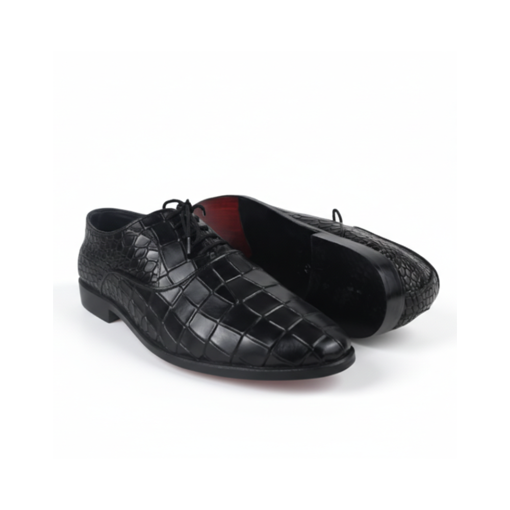 Pair of black dress shoes with textured finish on a white background
