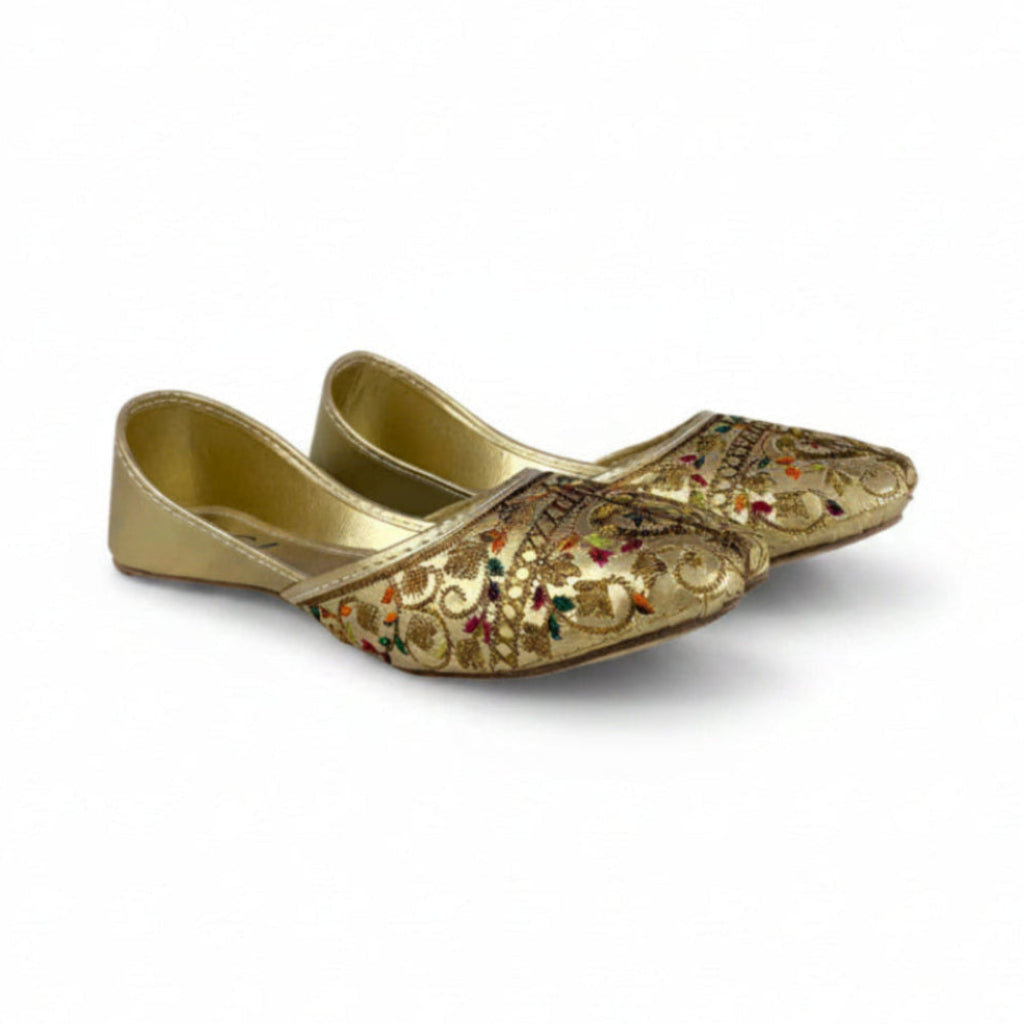 Pair of gold embroidered shoes on a white background
