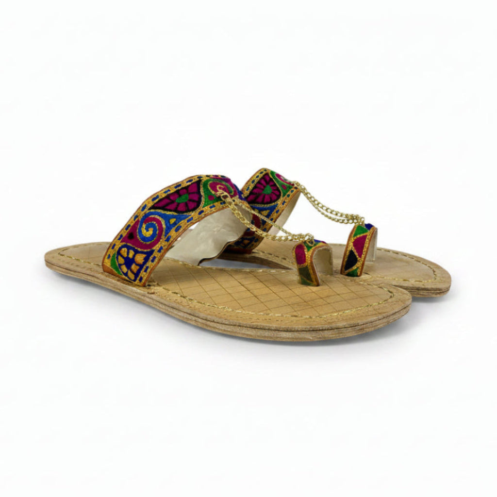 Colorful sandal with decorative straps on a white background