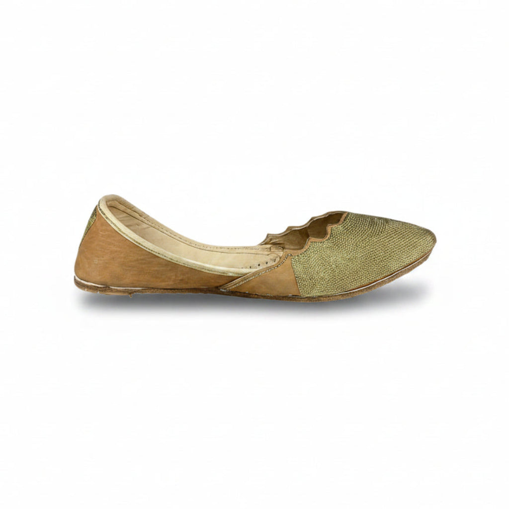 Gold flat shoes on a white background