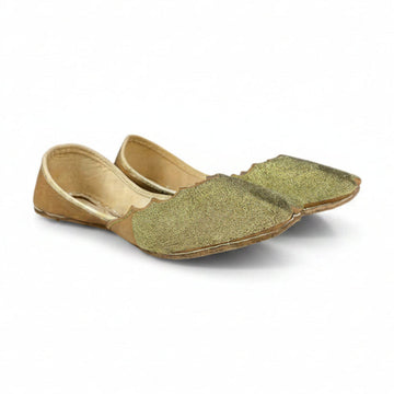 Gold flat shoes on a white background