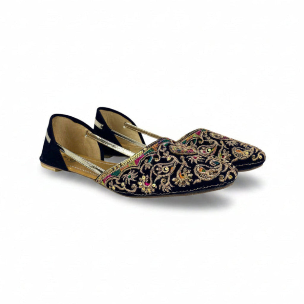 Pair of black embroidered shoes on a white background