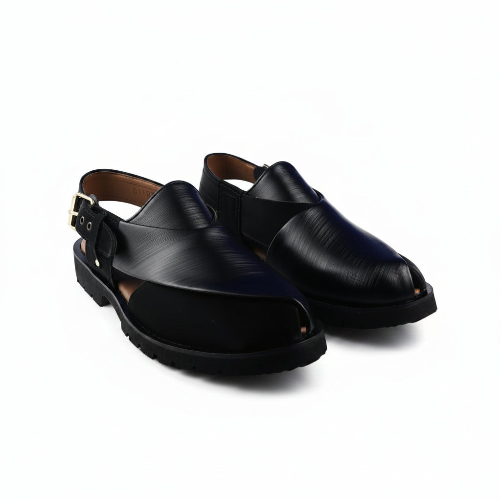 A pair of black  slingback clogs with a buckle strap and chunky lug sole, shown on a white background.