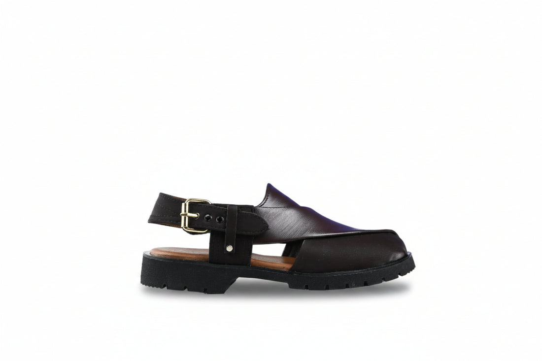 A pair of black  slingback clogs with a buckle strap and chunky lug sole, shown on a white background.