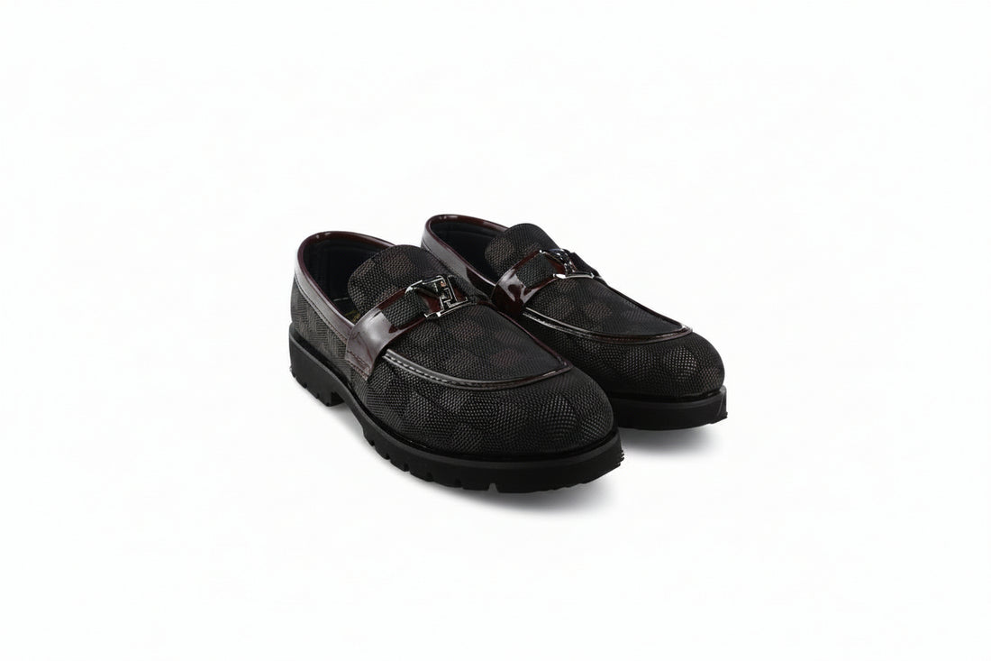 A pair of brown loafers with a textured pattern and a silver-tone horsebit detail on the strap, shown on a plain white background.