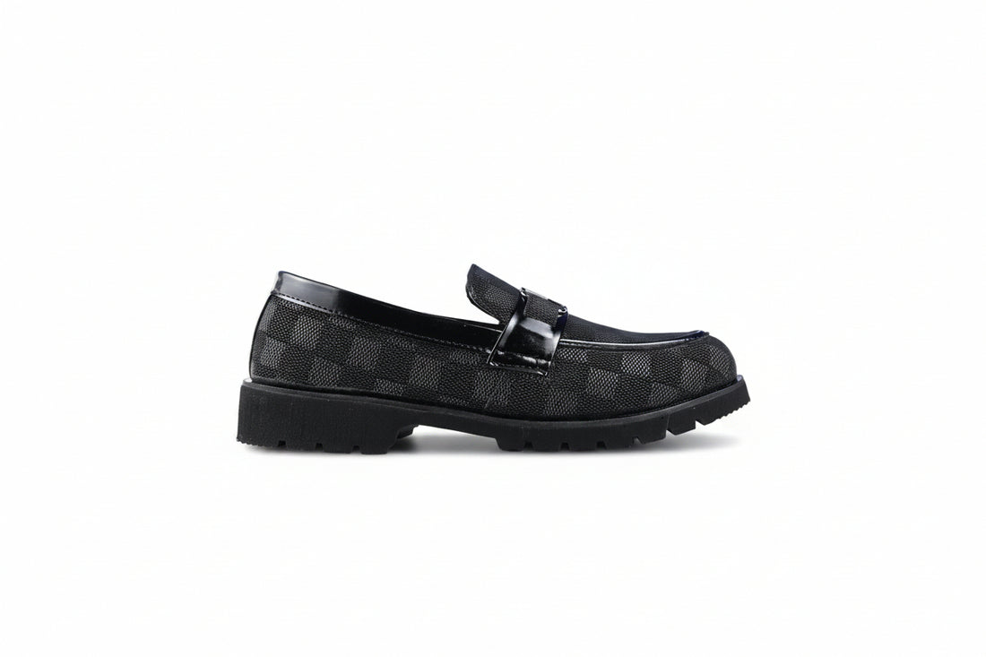 A pair of brown loafers with a textured pattern and a silver-tone horsebit detail on the strap, shown on a plain white background.