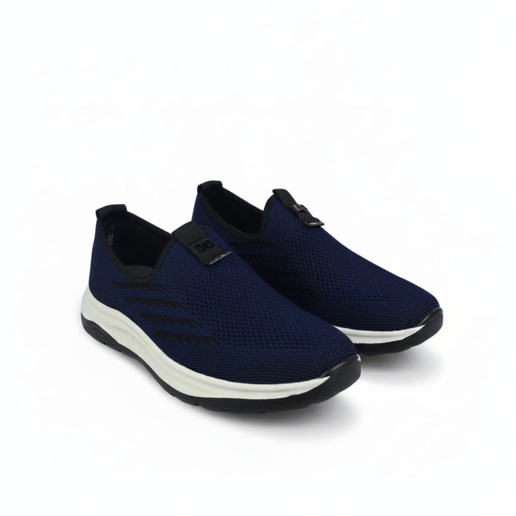 A pair of navy blue slip-on mesh sneakers with black accents and a white midsole, displayed on a clean white background.
