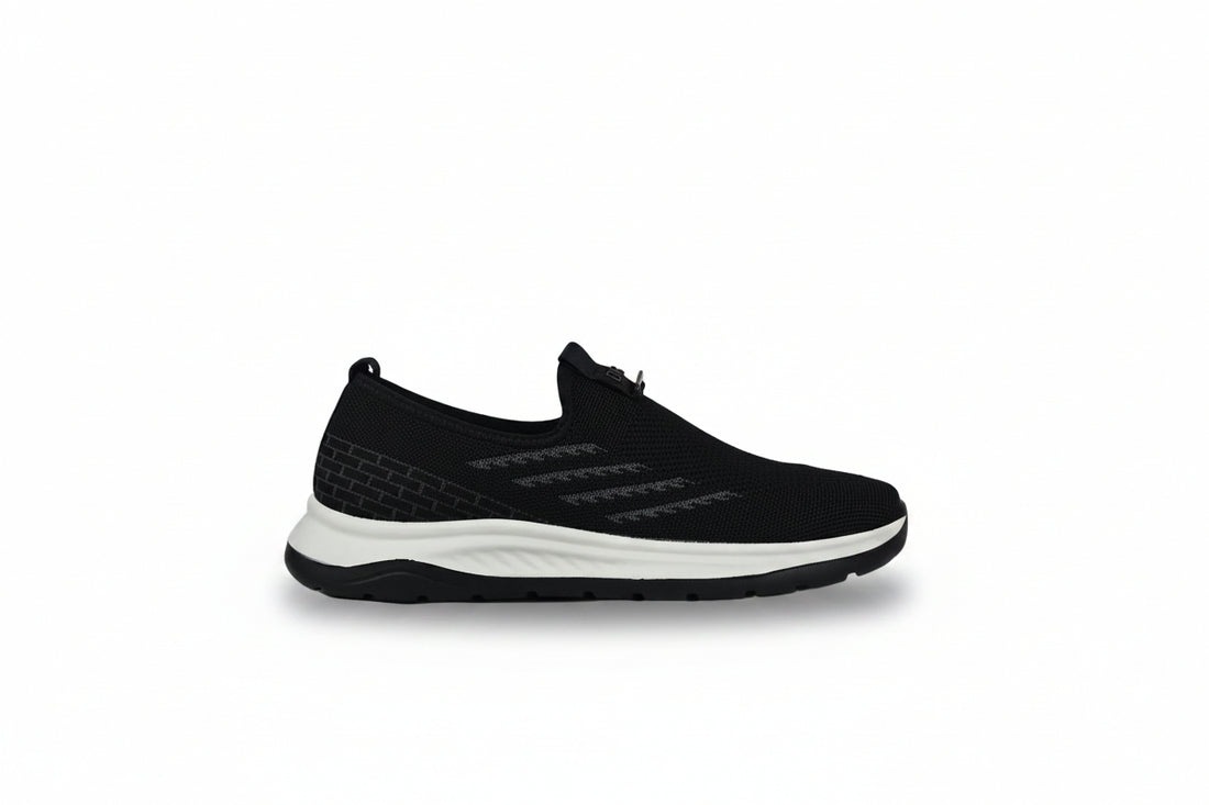 A pair of navy blue slip-on mesh sneakers with black accents and a white midsole, displayed on a clean white background.