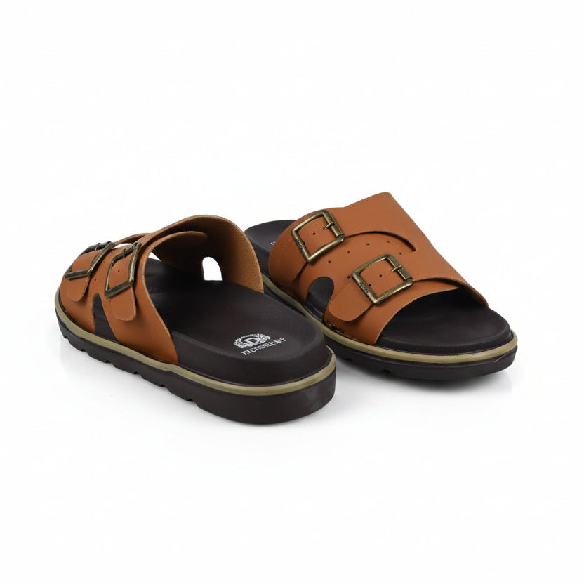 A pair of mustard double-strap slide sandals with black soles and gold-tone buckle details, shown on a plain white background.