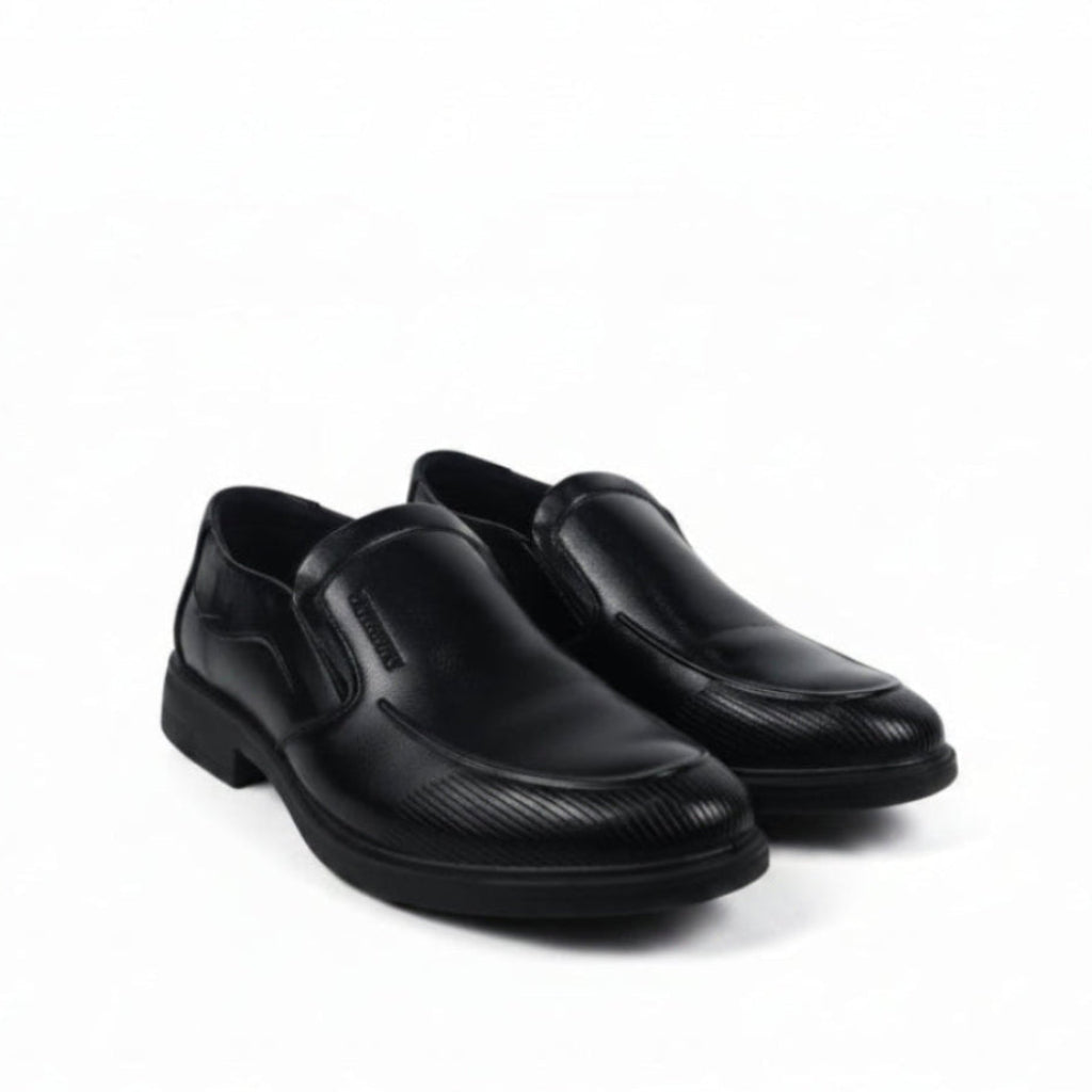A pair of men's black  slip-on dress shoes with a subtle textured pattern on the toe and sides, displayed against a plain white studio background.