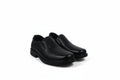 A pair of black slip-on dress shoes with low block heels, displayed on a clean white background.