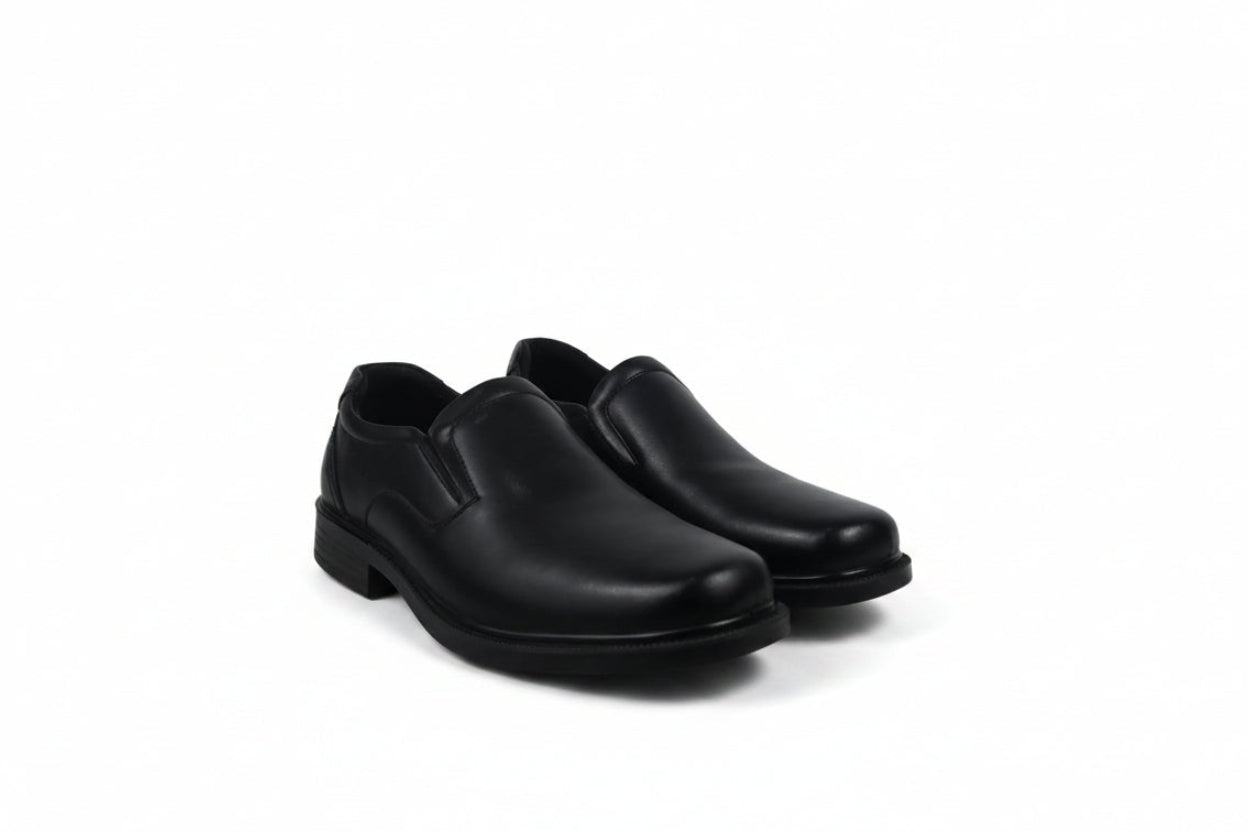 A pair of black slip-on dress shoes with low block heels, displayed on a clean white background.
