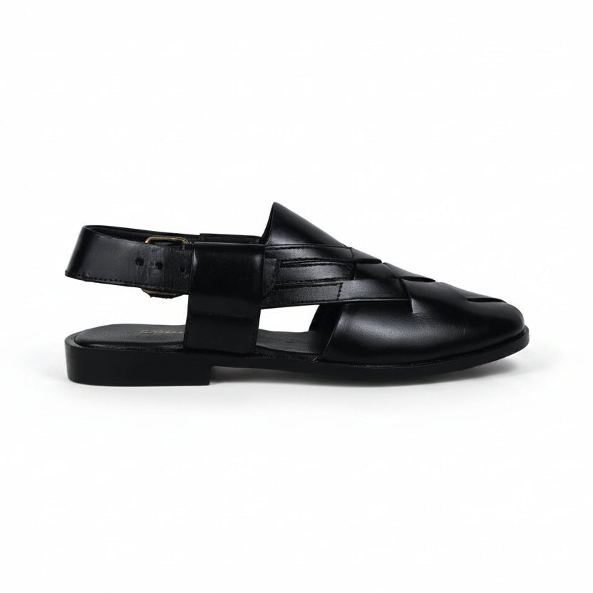 Black sandal with multiple straps on a light gray background