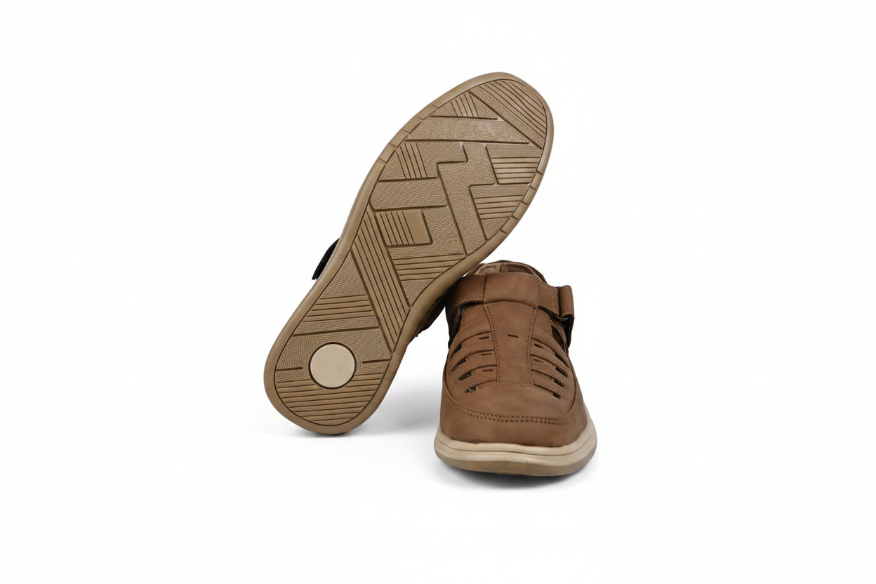 A pair of mustard slip-on shoes shown on a white studio background, with one shoe standing upright to display the side and the other lying on its side to show the textured brown outsole.