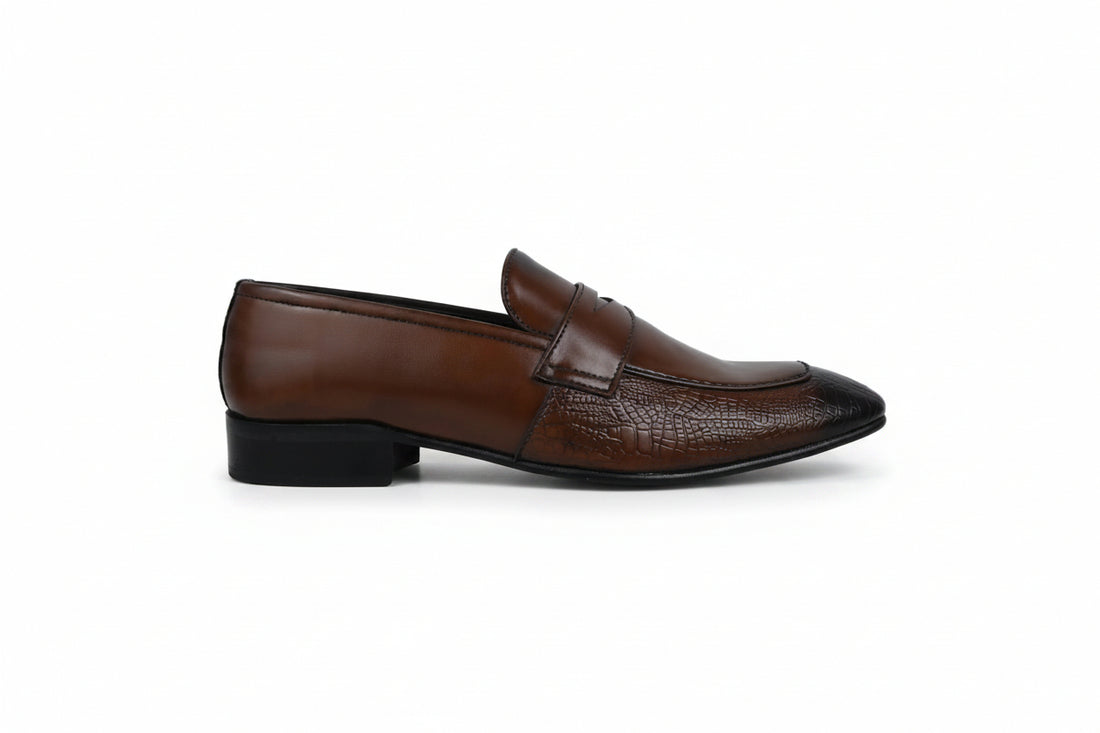 A pair of men's brown  penny loafers with a textured crocodile pattern on the toe caps, displayed on a white studio background.