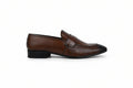 A single brown  penny loafer with a textured crocodile-embossed side panel and a black toe cap, shown in profile against a light gray background.