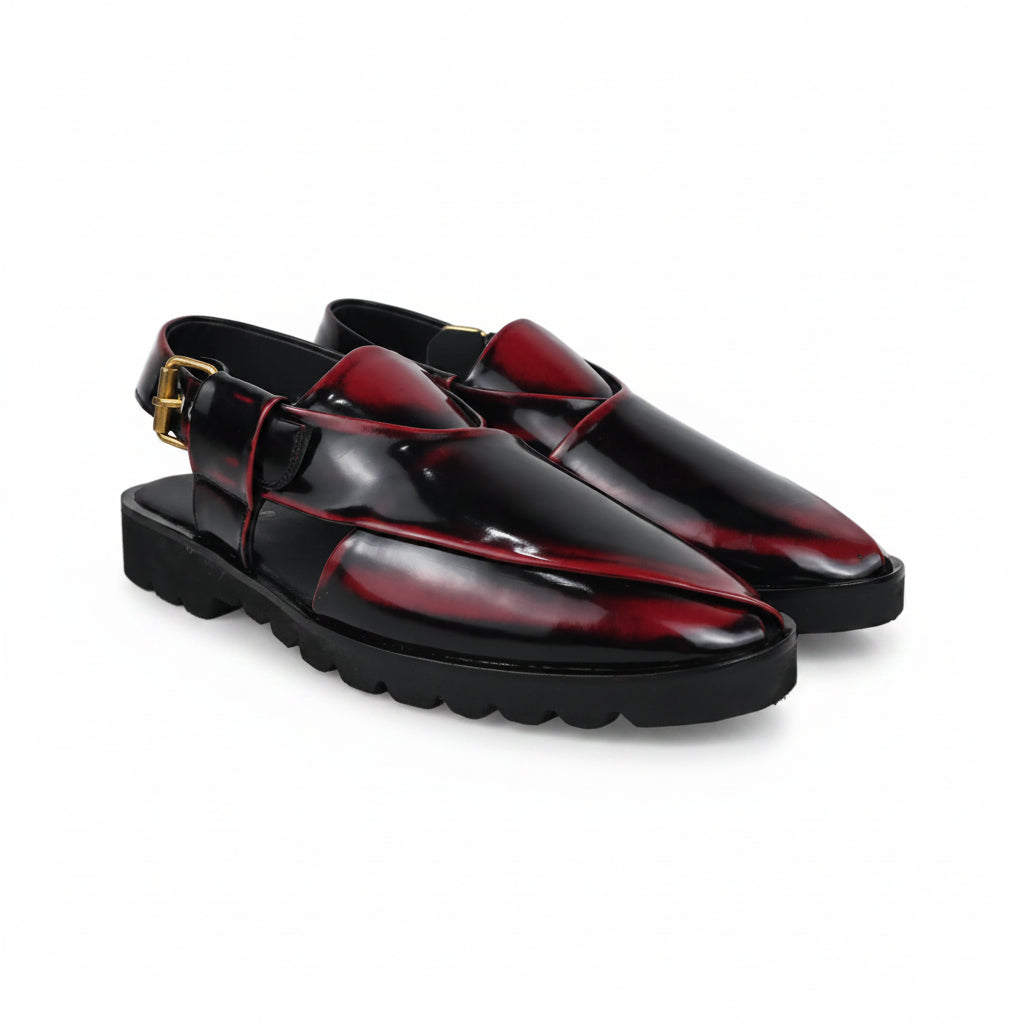 A pair of glossy black  clog-style loafers with deep red inlay panels and a small gold buckle detail, shown on a light gray background.