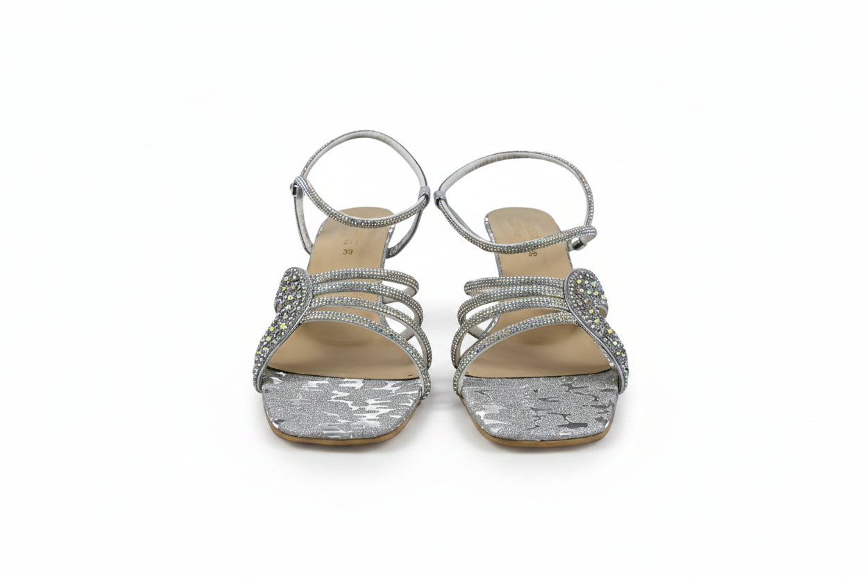 A pair of women's silver strappy sandals with rhinestone embellishments and square heels, shown against a plain white background.