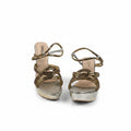 A pair of women's platform sandals with metallic gold braided straps and silver metallic platform soles, shown against a white background.