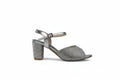 A single silver glittery block-heel sandal with an ankle strap, shown in a side profile against a light gray background.