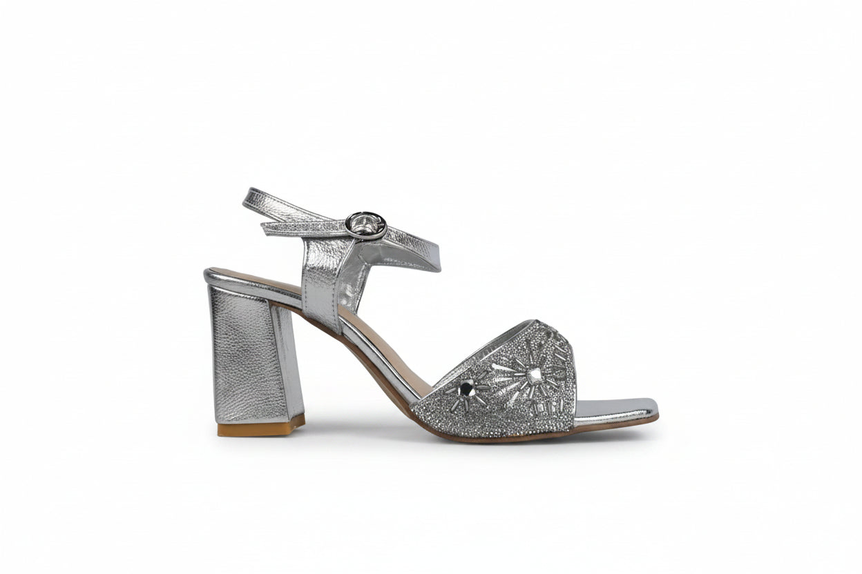 A single silver metallic high-heeled sandal with an ankle strap and a block heel, shown in profile against a light gray background.