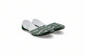 A pair of traditional Indian flat shoes (mulej) featuring a green and white patterned woven upper, green soles, and white inner lining, displayed on a light gray fabric background.