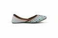 A single white flat shoe with a brown leather trim and a blue and green floral pattern on the toe cap, shown against a light gray background.