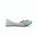 A single white flat shoe with intricate green and blue embroidered patterns on the toe, shown from a side profile against a light gray background.