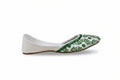 A single white flat shoe with green floral embroidery and beadwork on the toe cap, shown in profile against a light gray background.