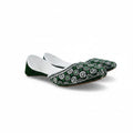 A pair of green velvet traditional flat shoes with intricate white floral embroidery and silver mirror work, displayed on a light gray fabric background.
