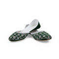 A pair of green velvet flat shoes with white floral embroidery on the toe, displayed on a light gray fabric background.