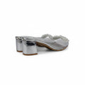 A pair of women's silver metallic block-heel thong sandals with a clear strap embellished with white beads, shown on a white surface.