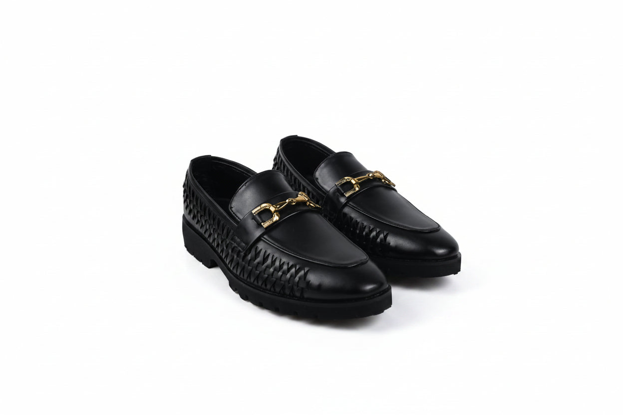 A pair of black leather loafers with a woven pattern on the sides and a gold-tone horsebit detail on the toe, displayed on a white studio background.