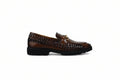 A single brown leather loafer with a braided woven pattern across the upper and a small gold-tone horsebit detail on the vamp, shown from a side profile against a light gray background.