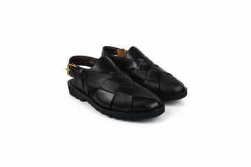 A pair of black leather slingback clogs with a woven pattern on the upper, photographed on a white studio background.
