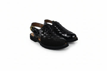 A pair of black woven leather slingback sandals with low block heels and gold-tone buckle details, displayed on a white studio background.