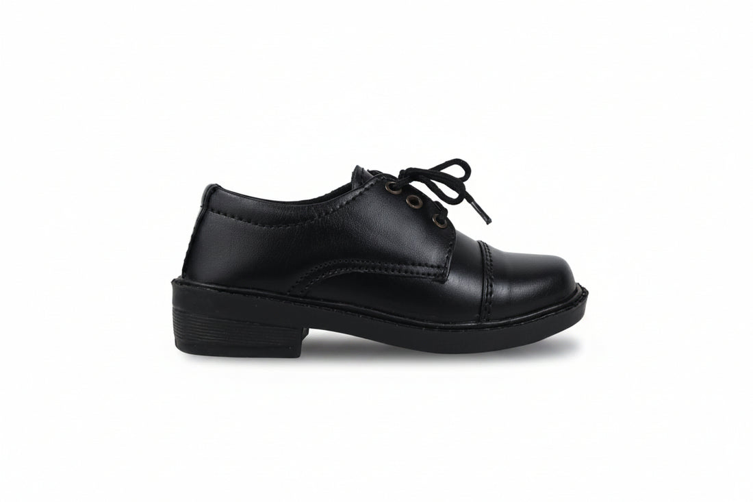 A pair of black leather lace-up shoes with low block heels, photographed on a light gray studio background.