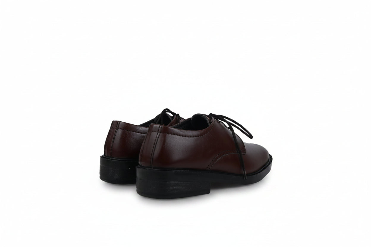 A pair of dark brown leather lace-up shoes with black soles, shown from a side-rear angle against a light gray fabric backdrop.