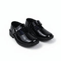 A pair of black patent leather Mary Jane school shoes with hook-and-loop straps, shown on a plain white background.