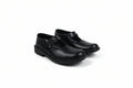 A pair of black Mary Jane school shoes with low block heels and buckle straps, photographed on a white studio background.
