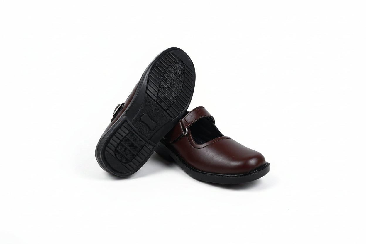 A pair of dark brown leather Mary Jane shoes with black soles, with one shoe standing upright to show the sole and the other lying on its side showing the side profile.