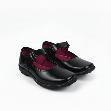 A pair of black Mary Jane school shoes with magenta pink lining, shown on a white studio background.