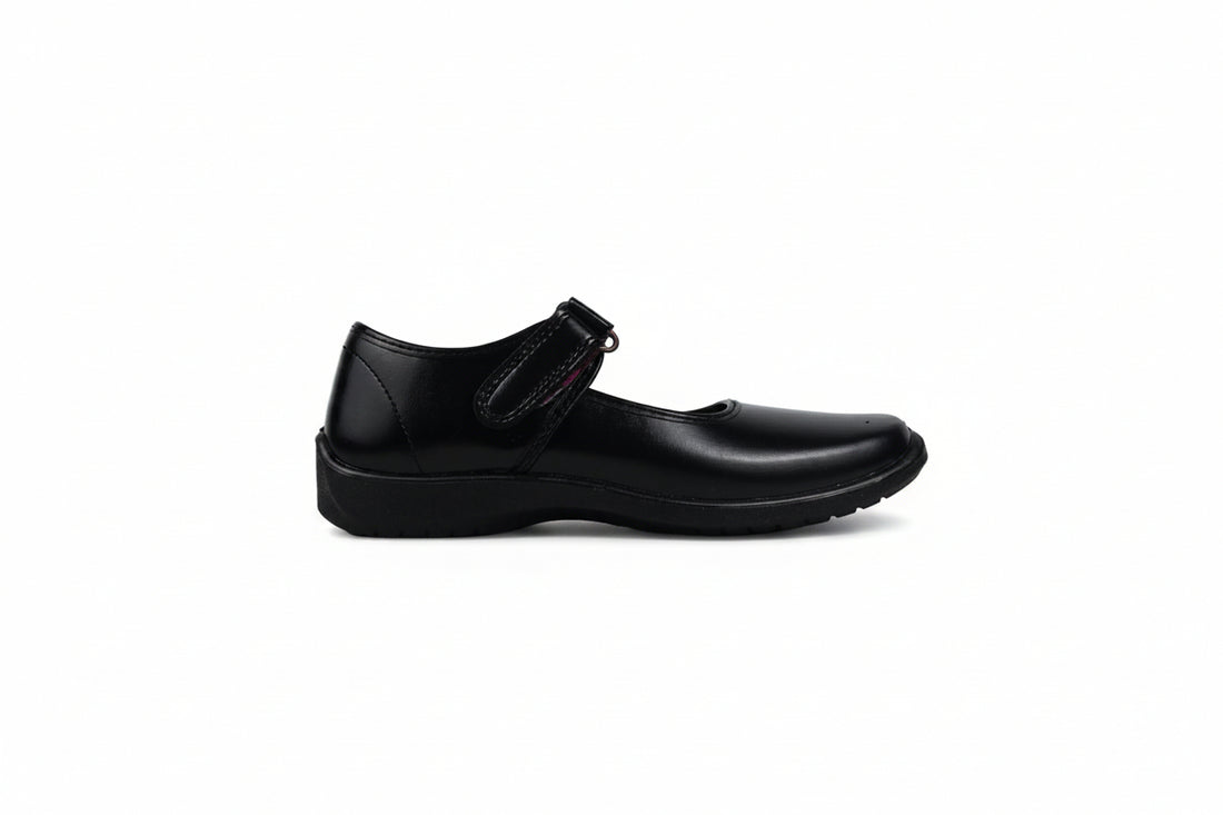 A pair of black Mary Jane school shoes with magenta pink lining, shown on a white studio background.