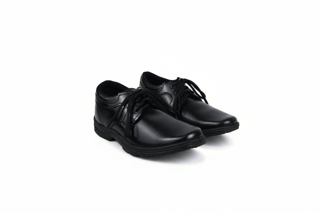 A pair of black leather lace-up dress shoes photographed on a plain white studio background.