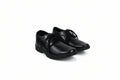 A pair of black leather lace-up dress shoes photographed on a plain white studio background.