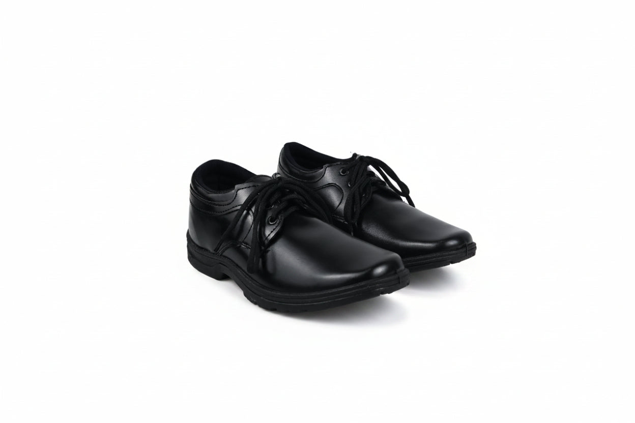 A pair of black leather lace-up dress shoes photographed on a plain white studio background.