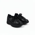 A pair of black low-top lace-up shoes with black soles, photographed on a plain white studio background.